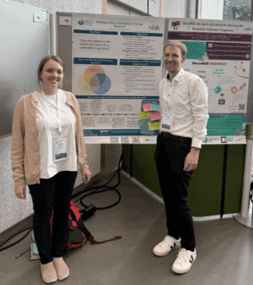 Participatios in front of presentation board